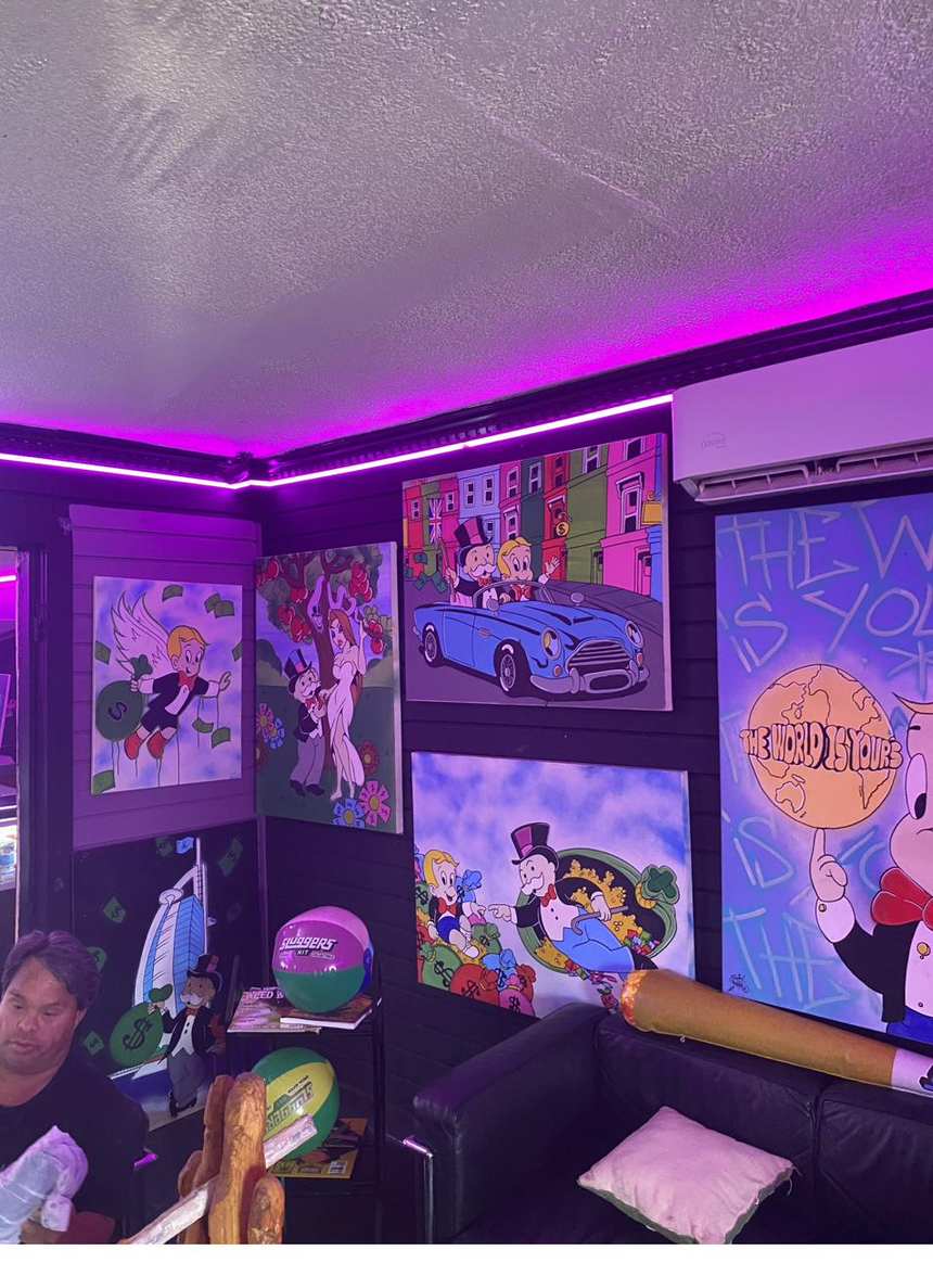The lounge wall under magenta cove lighting